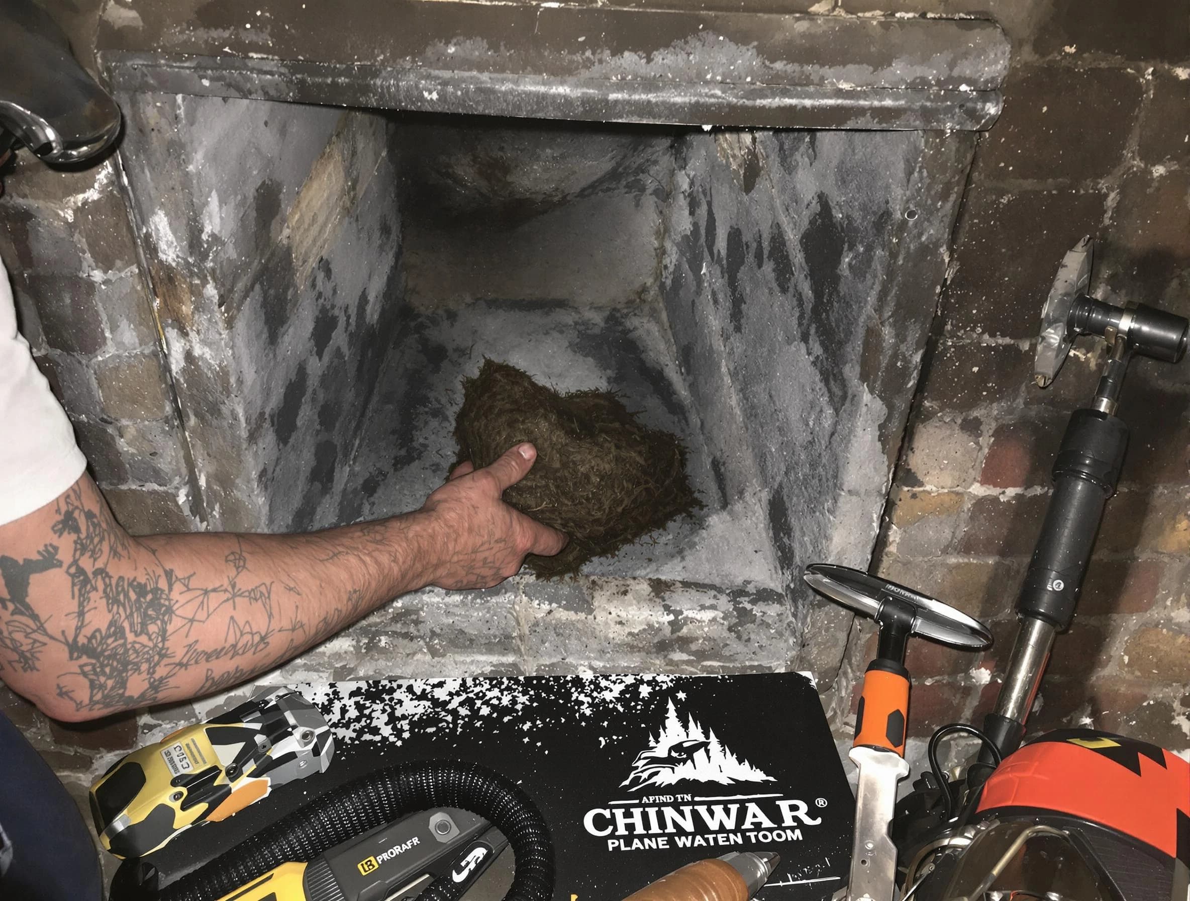 East Providence Chimney Sweep safely removing debris and screening chimney in East Providence, RI